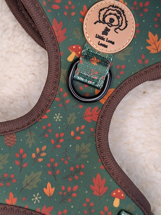 Adjustable Dog harness with a Autumn leaves pattern and a brand logo on a green background