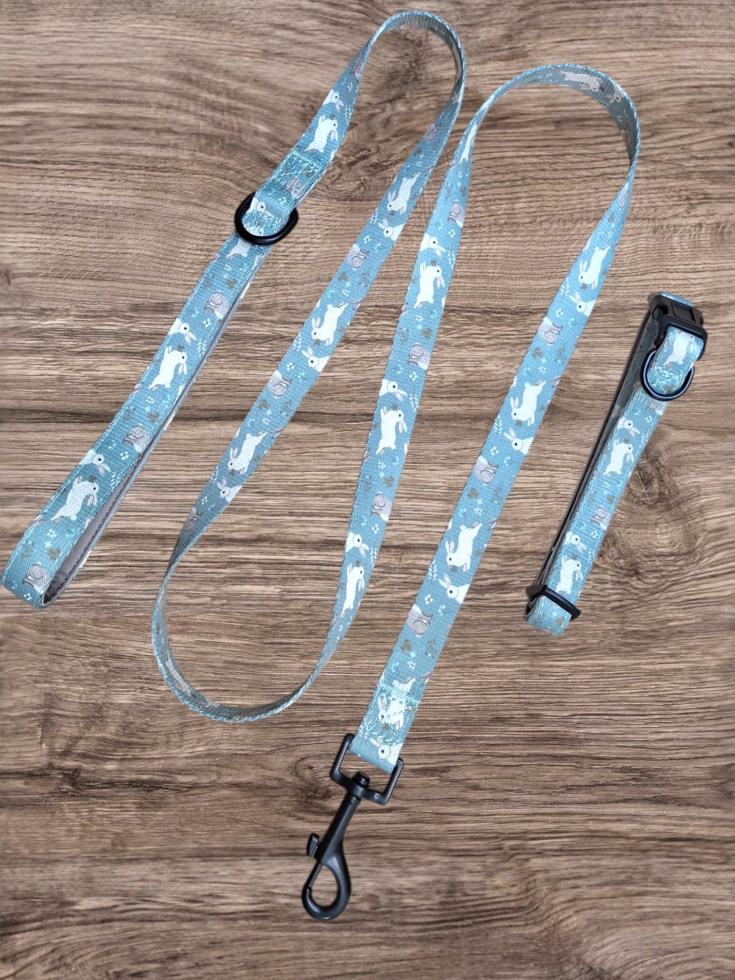 Dog leash with rabbits pattern on a wooden surface