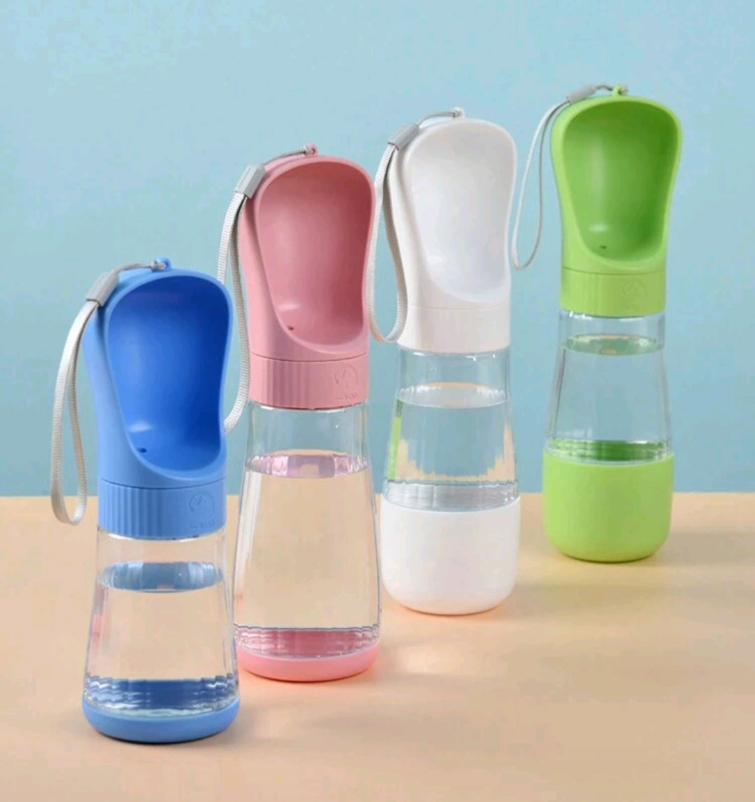 Four colorful water bottles with different designs on a beige surface against a light blue background.