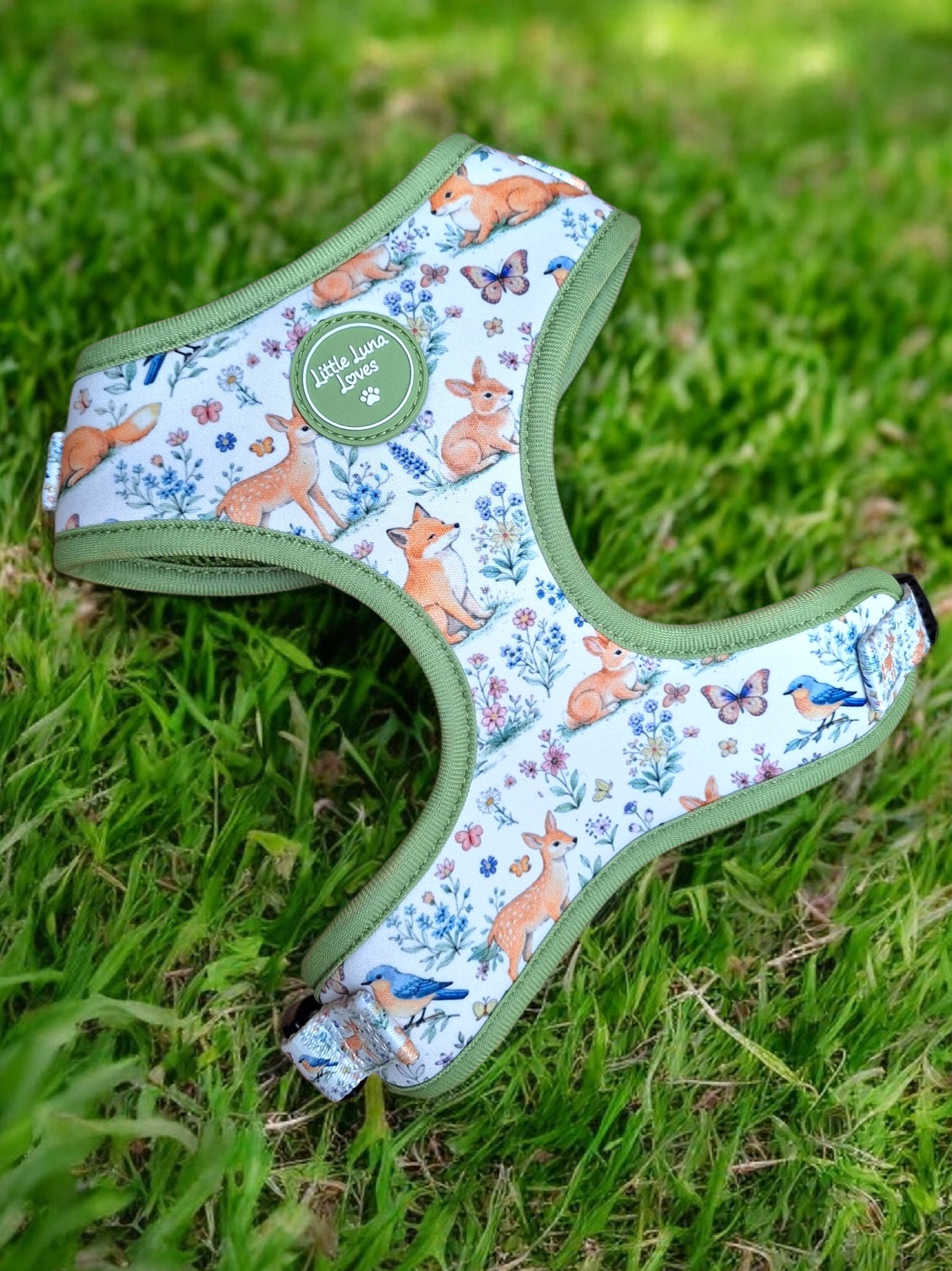 Dog harness with animal pattern on grass