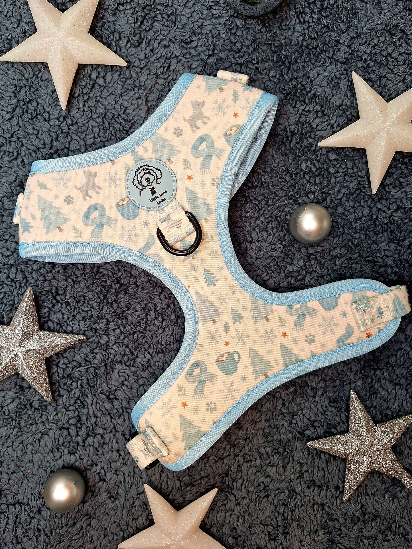 Dog harness with star pattern on a textured surface with decorative stars and balls